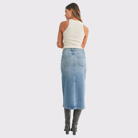 Meet the Denim Utility Pocket Midi Skirt by Just Black! This piece is effortlessly chic and feminine, with a slit in the front for added style and comfort. Transition from summer to fall easily, by pairing this skirt with tall boots and a cozy sweater. This piece can be taken from day to night, making this a versatile piece needed in every wardrobe!